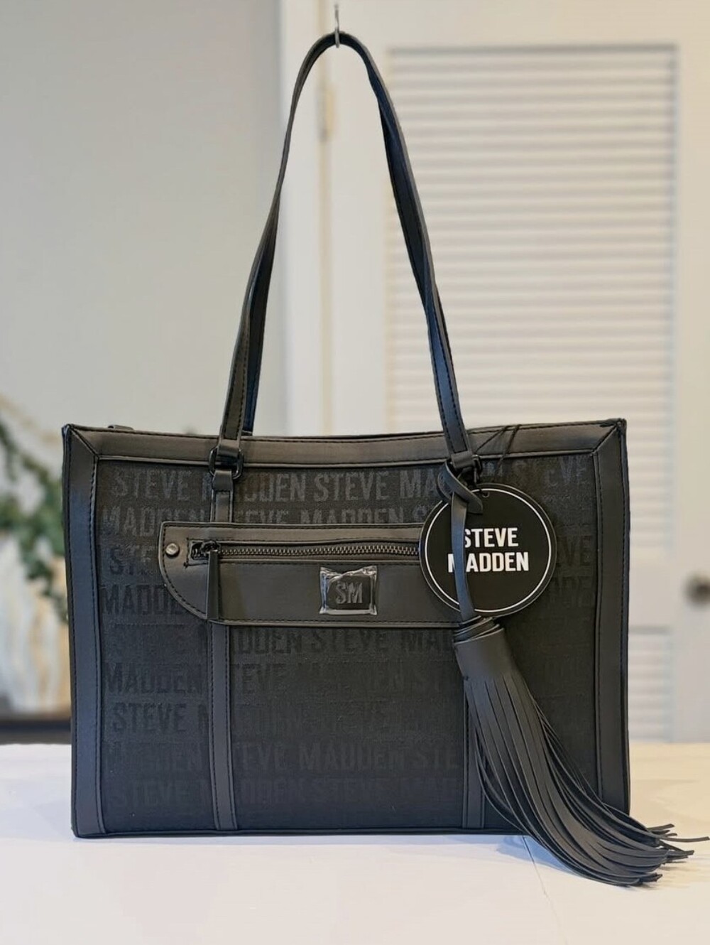 Steve Madden Black Logo Tote with Tassel Charm and Front Pocket